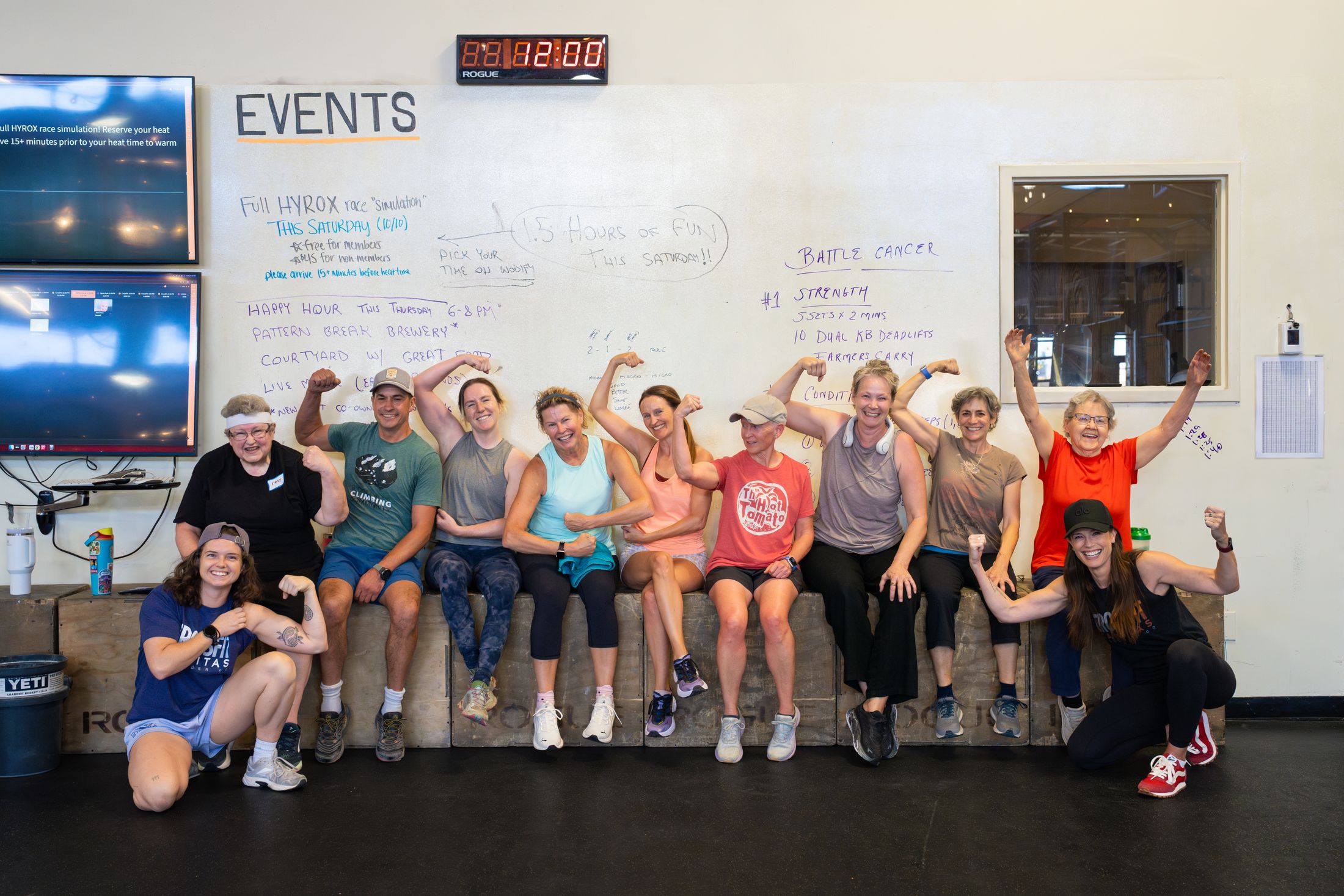 The Community Strength group gathered on the boxes, flexing and laughing together