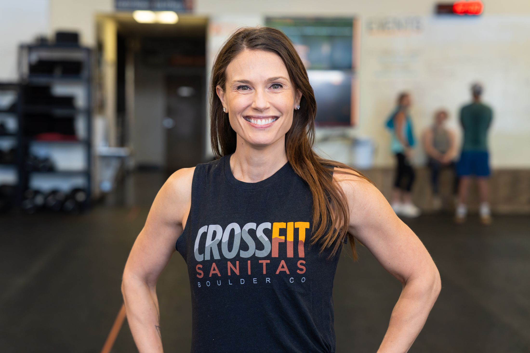 Rosemary Calderone smiling in a CrossFit Sanitas tank top inside the gym